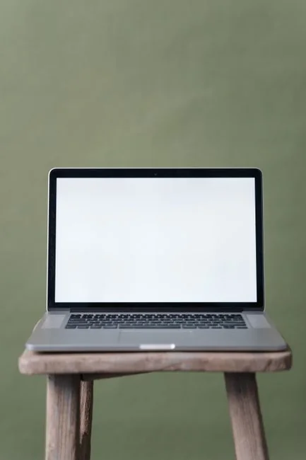 Person shopping online using a laptop and credit card, highlighting e-commerce convenience.